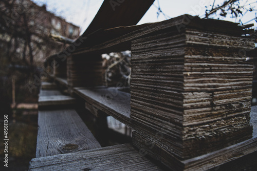 Selective focus of wooden pallets on a background of a building photo