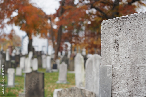 Fototapeta Closeup of cemetery gravestones in autumn