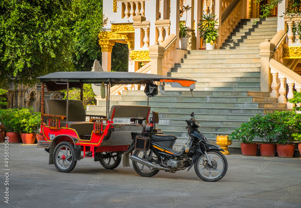 Tuk tuk taxi on street outside grand staircase to hotel or resort. Tuk tuk taxi on street outside grand staircase to hotel or resort.