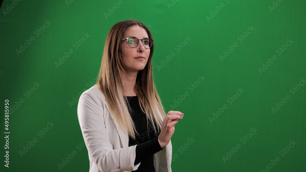 Young woman taps on a large imaginary touchscreen - studio photography Young woman taps on a large imaginary touchscreen - studio photography