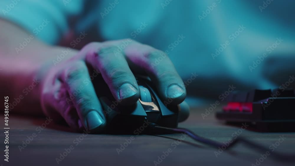 Gamer typing on backlight keyboard close-up, man playing video game. Male hands pushing buttons on computer mouse. Programmer or hacker working in networks, cyberspace. Gamer typing on backlight keyboard close-up, man playing video game. Male hands pushing buttons on computer mouse. Programmer or hacker working in networks, cyberspace.