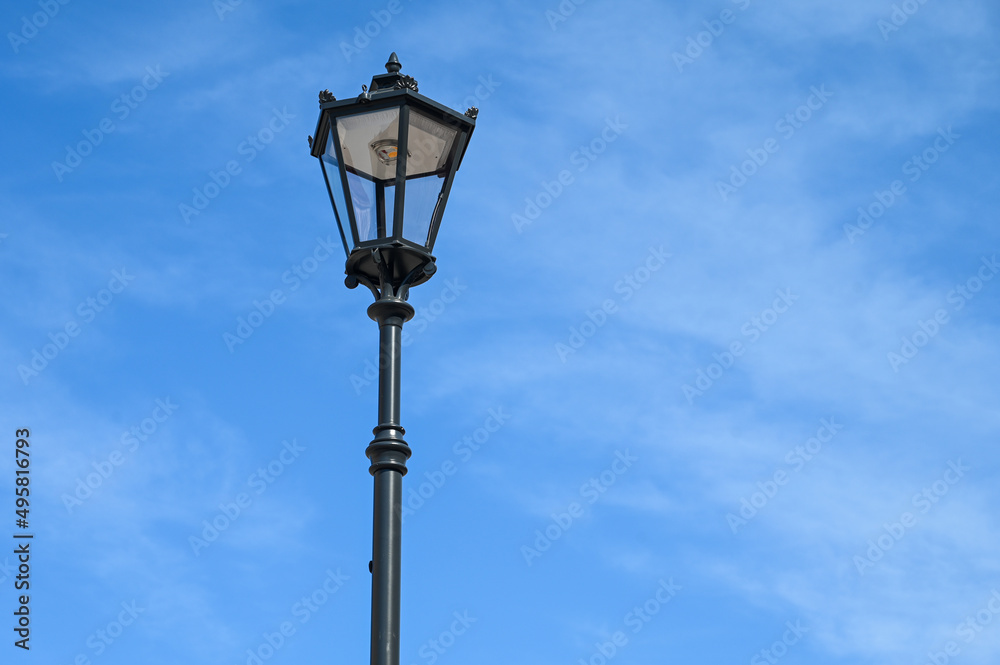 Street light against blue sky. Illuminated street light in city. 