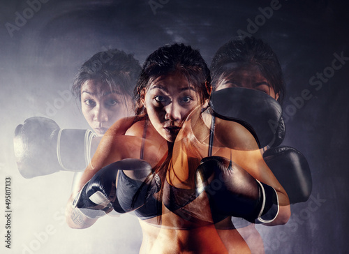 Fototapeta Naklejka Na Ścianę i Meble -  Your toughest opponent is you. Portrait of a focused young boxer working out with a multiple exposure effect.
