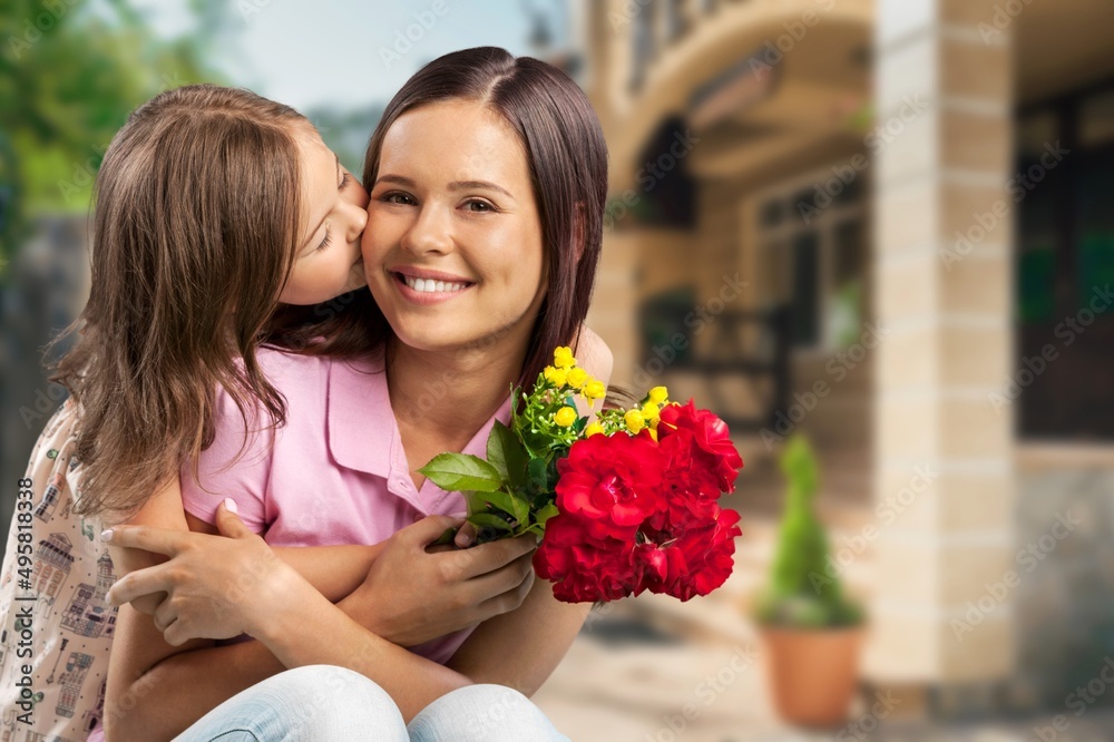 Happy woman child with tulips smiling with eyes. celebrating holiday at home Happy woman child with tulips smiling with eyes. celebrating holiday at home