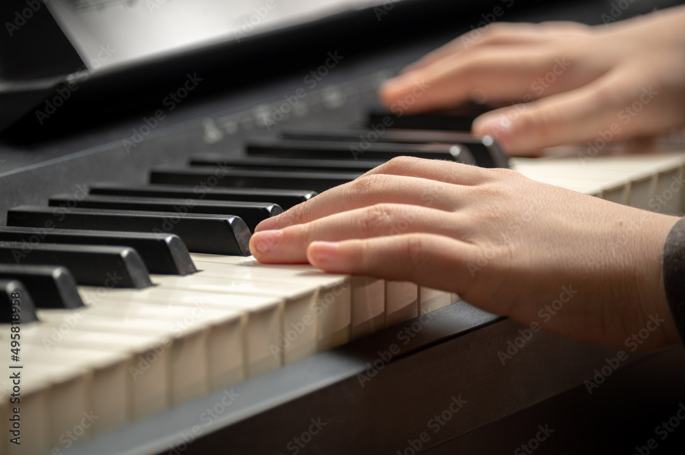 Child's hand presses the piano keys Child's hand presses the piano keys