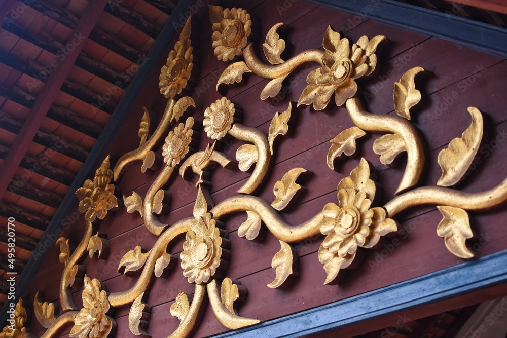 The wood carvings at the roof gable on the main chapel of Nong Bua temple in Nan province, THAILAND.