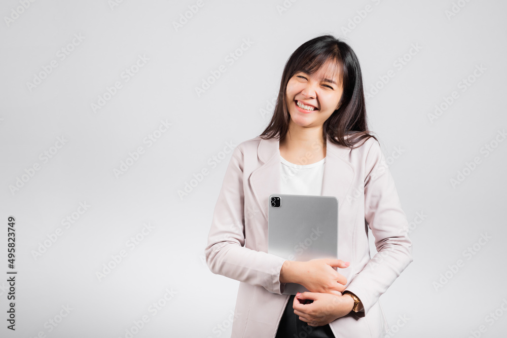 Portrait of Asian beautiful young woman smiling holding tablet computer, Happy lifestyle female teen hugging digital tablet pc, studio shot isolated on white background, university e-book equipment Portrait of Asian beautiful young woman smiling holding tablet computer, Happy lifestyle female teen hugging digital tablet pc, studio shot isolated on white background, university e-book equipment
