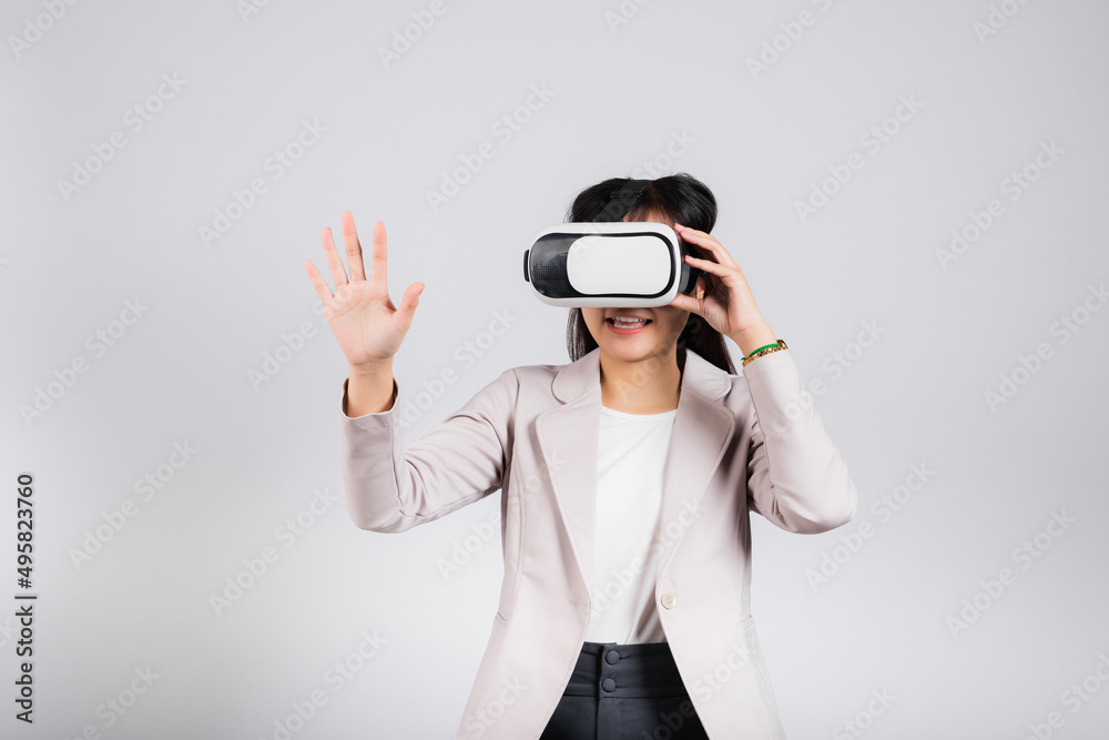 Smiling woman confidence excited wear VR headset device touching air during virtual reality experience isolated white background, Asian happy portrait female playing video game studio shot, copy space Smiling woman confidence excited wear VR headset device touching air during virtual reality experience isolated white background, Asian happy portrait female playing video game studio shot, copy space