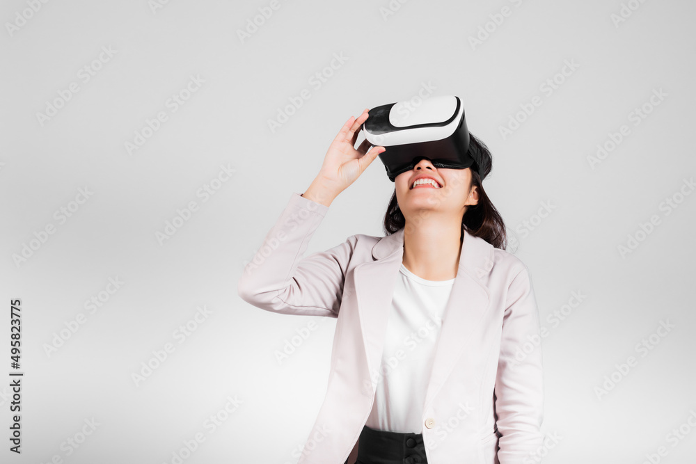 Smiling woman confidence excited wear VR headset device during virtual reality experience isolated white background, Asian happy portrait female playing video game studio shot, copy space Smiling woman confidence excited wear VR headset device during virtual reality experience isolated white background, Asian happy portrait female playing video game studio shot, copy space