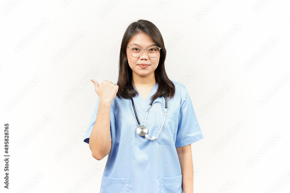 Showing and Pointing Product With Thumb Of Asian Young Doctor Isolated On White Background Showing and Pointing Product With Thumb Of Asian Young Doctor Isolated On White Background