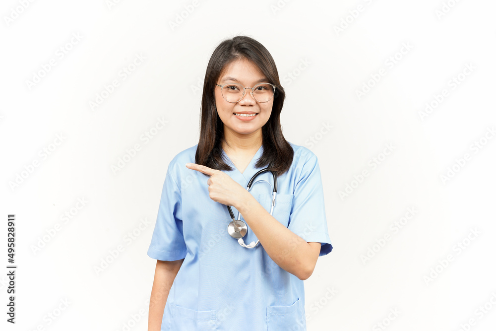 Showing Product and Pointing Side Of Asian Young Doctor Isolated On White Background Showing Product and Pointing Side Of Asian Young Doctor Isolated On White Background