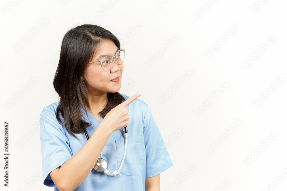 Showing Product and Pointing Side Of Asian Young Doctor Isolated On White Background Showing Product and Pointing Side Of Asian Young Doctor Isolated On White Background