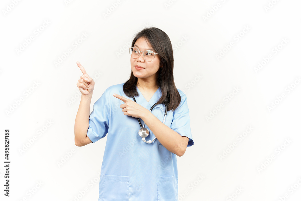 Showing Product and Pointing Side Of Asian Young Doctor Isolated On White Background Showing Product and Pointing Side Of Asian Young Doctor Isolated On White Background
