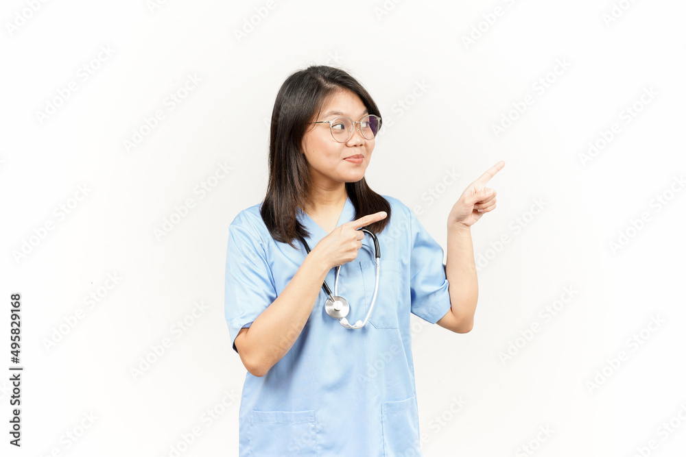 Showing Product and Pointing Side Of Asian Young Doctor Isolated On White Background Showing Product and Pointing Side Of Asian Young Doctor Isolated On White Background