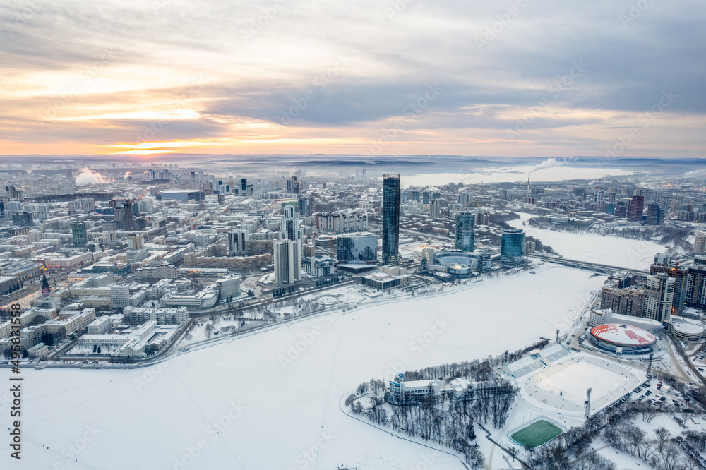 Fototapeta premium Yekaterinburg aerial panoramic view in Winter at sunset. Yekaterinburg city and pond in winter.