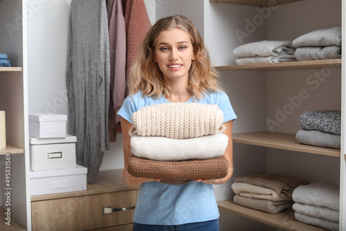 Woman with stack of clean c...
