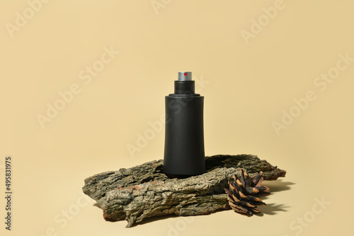 Bottle of woody perfume on light color background photo