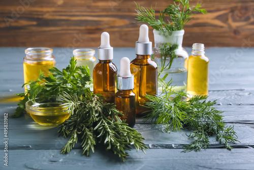 Fototapeta Naklejka Na Ścianę i Meble -  Bottles of natural essential oils on wooden background