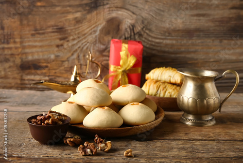 Tasty Eastern sweets on wooden table