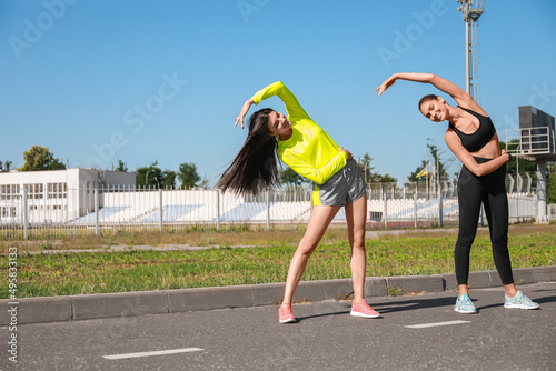 Sporty young women training on sunny day