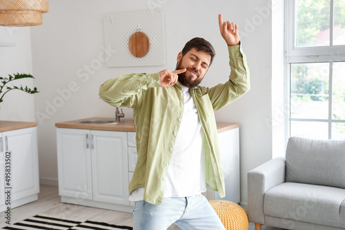 Handsome man dancing in kit...