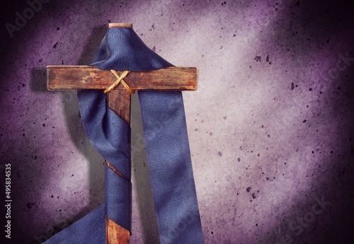 Holy Week concepts. Wooden cross in blue vintage ribbon