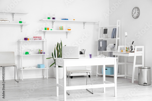 Interior of modern laboratory with workplace and chemical glassware © Pixel-Shot