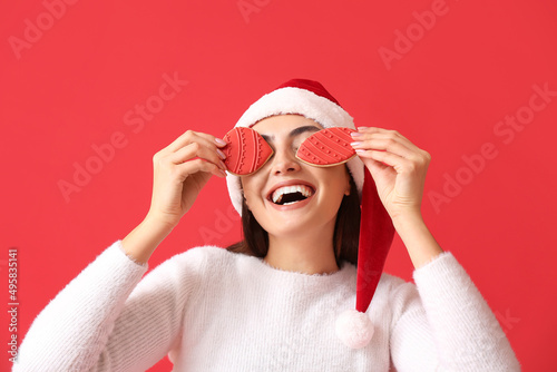 Joyful woman in santa hat h...