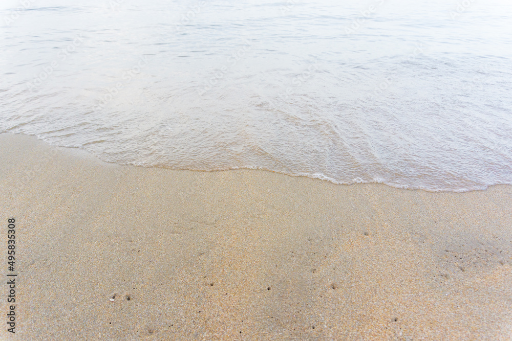 Sea wave on sandy beach morning sun light Sea wave on sandy beach morning sun light