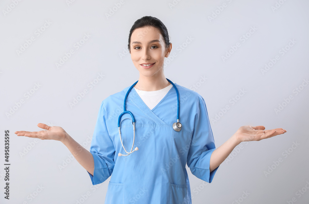 Portrait of female doctor on grey background Portrait of female doctor on grey background