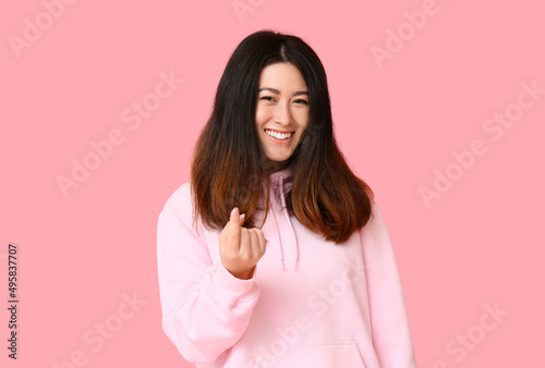 Young Asian woman in hoodie...