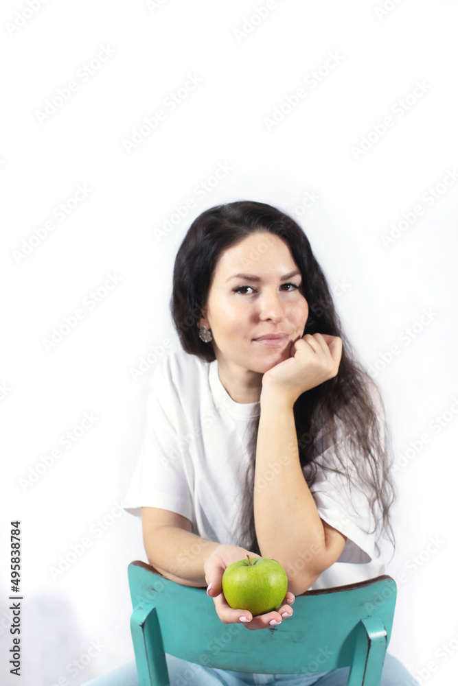 Smiling woman with apple. The concept of spring and vitamins. Detox food. Front view. Smiling woman with apple. The concept of spring and vitamins. Detox food. Front view.