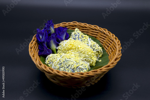 Pean Pap  the name of colorful Thai desserts Pean Pap  the name of colorful Thai desserts sprinkled with sugar before eating and placed in a basket. with butterfly pea flowers  including Clipping Path
