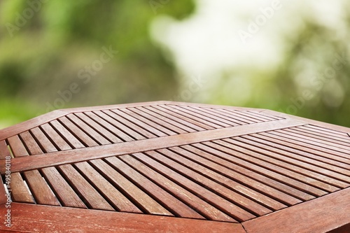 Outdoor table on tropical plants, palms and jungle background