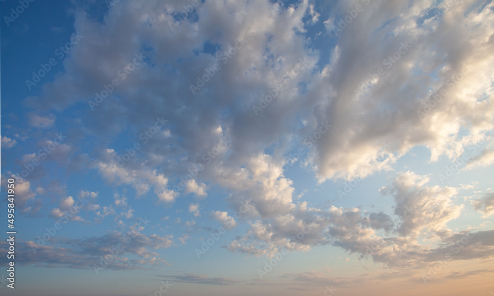 Puffy white clouds in blue sky background