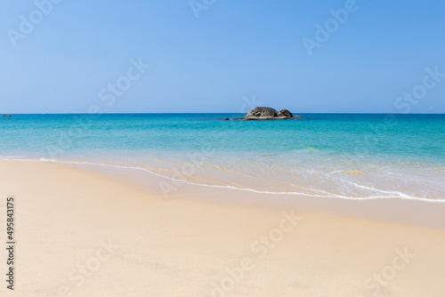 Clean sandy beach with beautiful blue sea and clear sky, tropical beach in south of Thailand, nature background