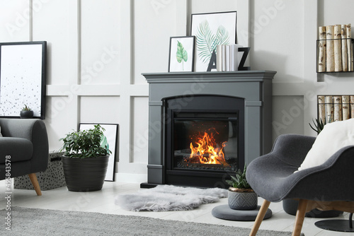 Print op canvas Stylish living room interior with electric fireplace and comfortable furniture