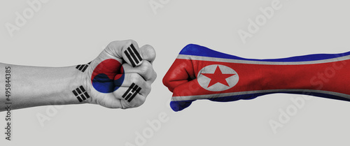 north korea vs south korea flag national painted on fist. Concept of politics, economy conflicts. photo