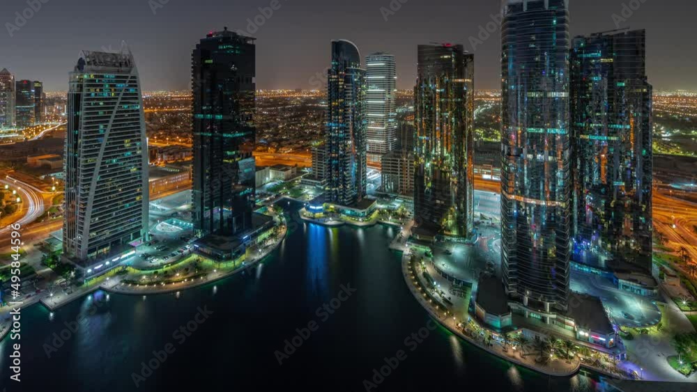 Tall residential buildings at JLT aerial all night timelapse, part of the Dubai multi commodities centre mixed-use district. Tall residential buildings at JLT aerial all night timelapse, part of the Dubai multi commodities centre mixed-use district.