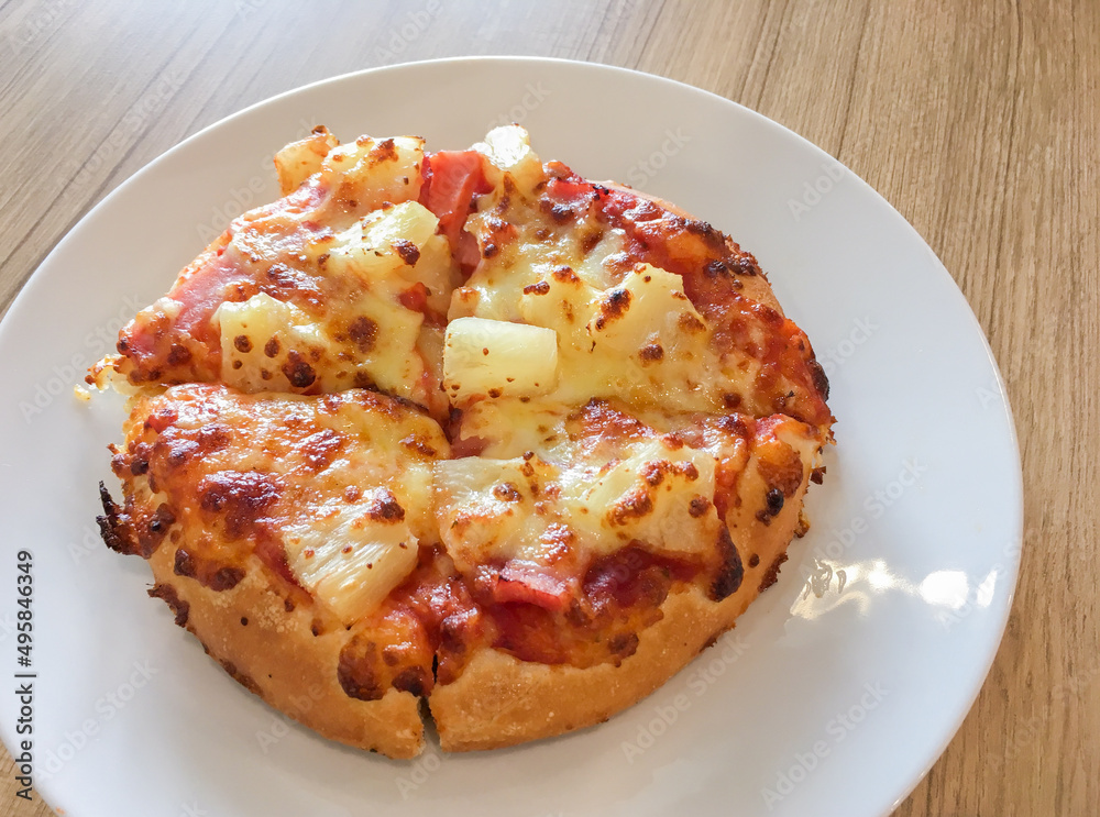 Hawaiian pizza and cheese on the dish Hawaiian pizza and cheese on the dish