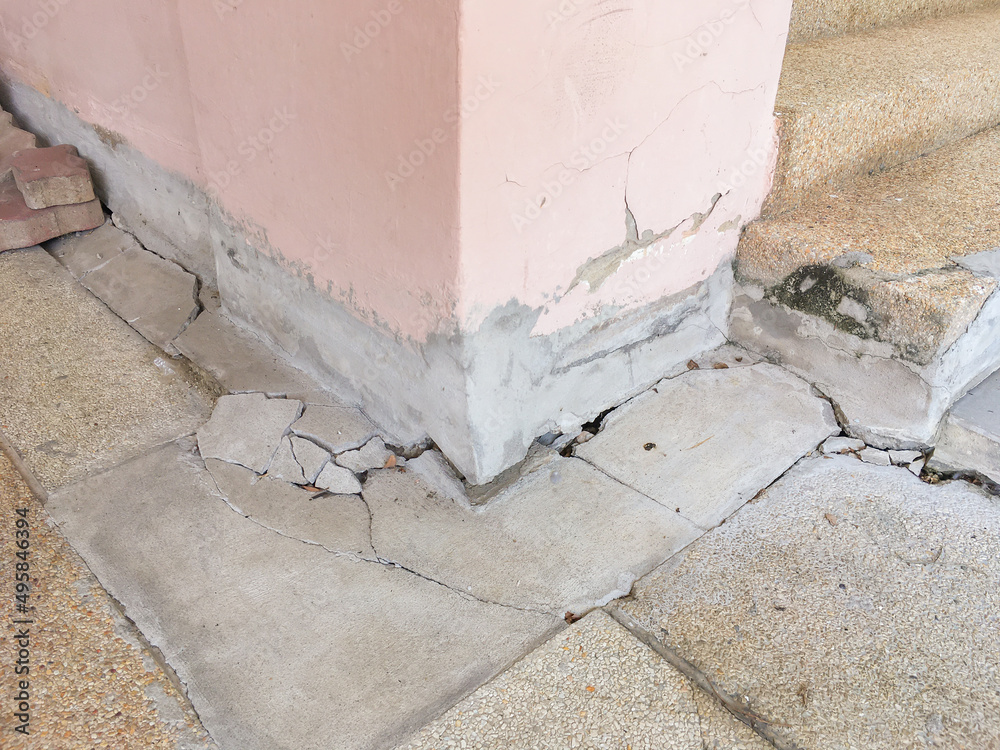 Collapsed or cracked concrete basement floor and pole