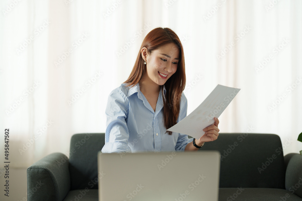Attractive asian woman working for financial with laptop computer and paperwork at home. Attractive asian woman working for financial with laptop computer and paperwork at home.