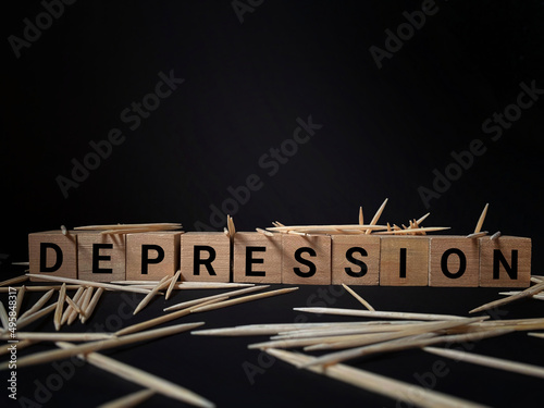 Depression text in dark background. Written on wooden blocks. Mental health concept. Stock photo.