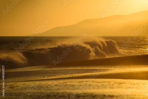 Gold sky and ocean water. Golden sunrise sunset over the sea waves. Sunrise over the ocean. Paradise beach.