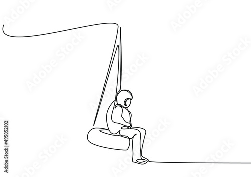 a calm person with a thoughtful hand in his pocket sitting on a swing made of wheels