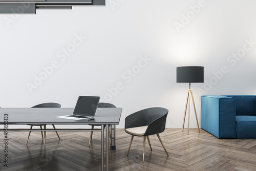 Bright concrete and wooden meeting room interior with furniture, ceiling lamp and laptop device on table. Workplace and conference concept. 3D Rendering.