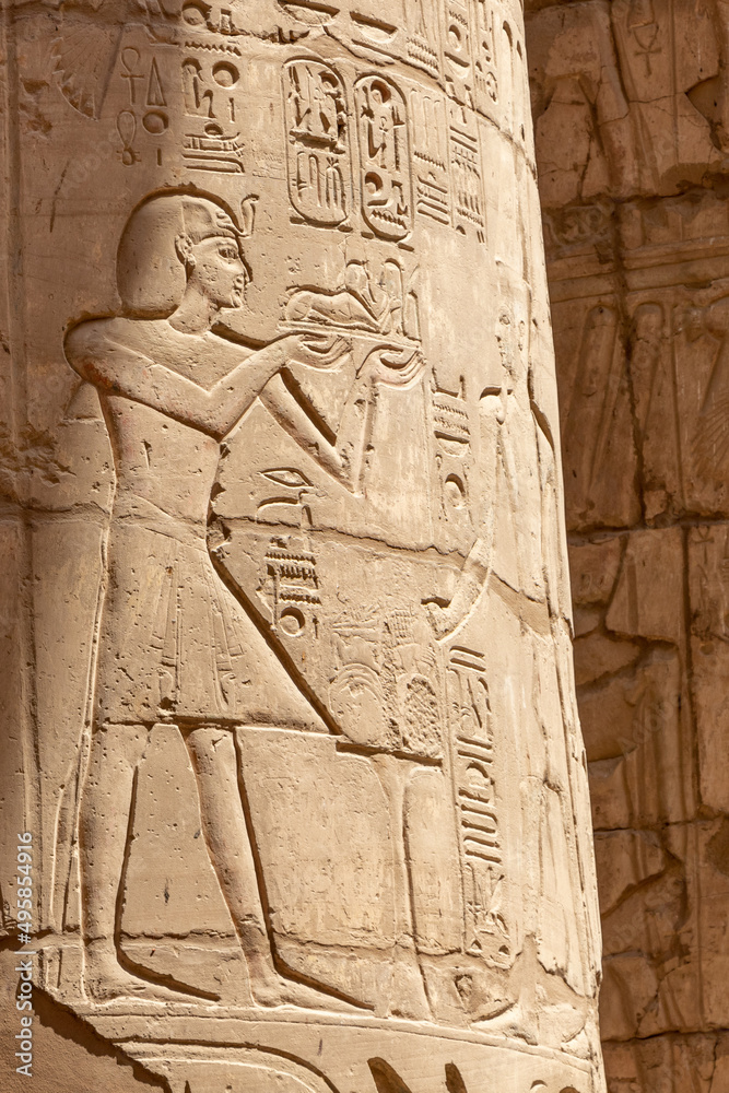 Massive columns inside beautiful Egyptian temple in Luxor with hieroglyphics, and ancient symbols. Karnak temple. Massive columns inside beautiful Egyptian temple in Luxor with hieroglyphics, and ancient symbols. Karnak temple.