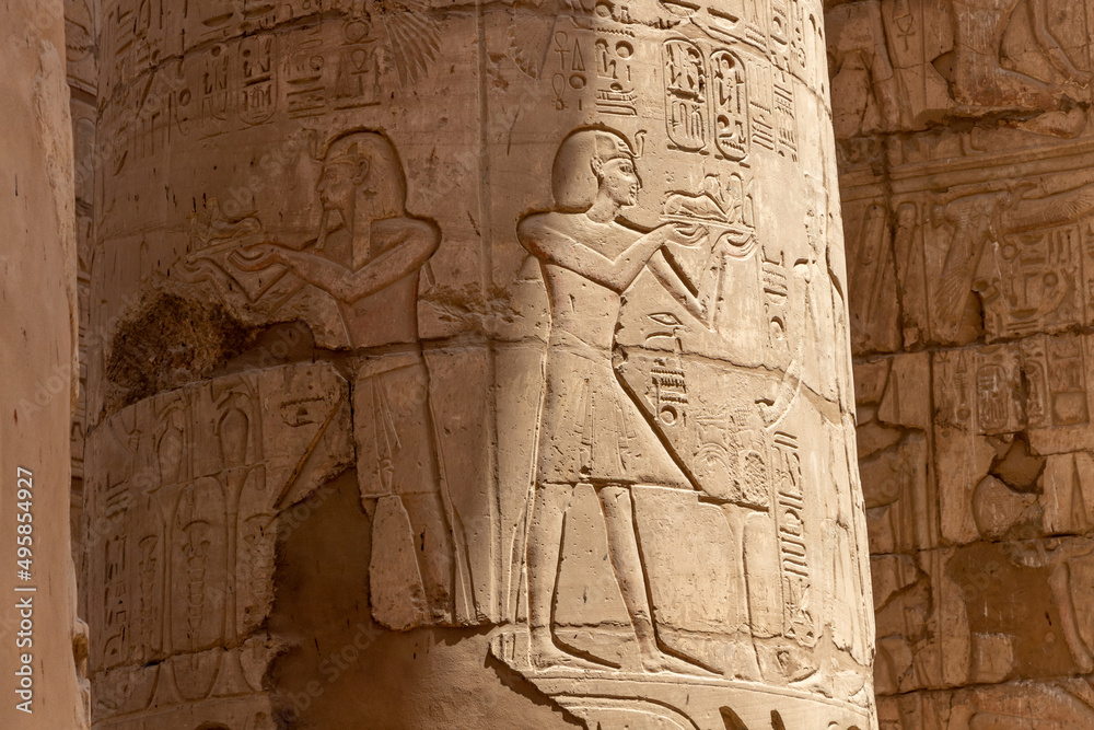 Massive columns inside beautiful Egyptian temple in Luxor with hieroglyphics, and ancient symbols. Karnak temple. Massive columns inside beautiful Egyptian temple in Luxor with hieroglyphics, and ancient symbols. Karnak temple.