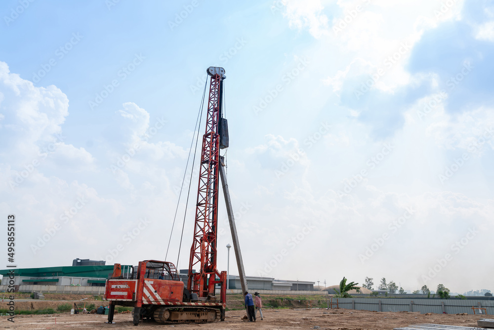 The pile driver is raising the piles and hammering The pile driver is raising the piles and hammering