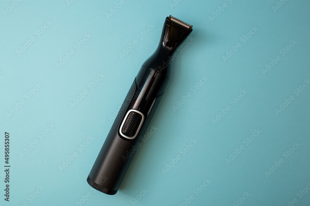 Electric shaver with attachments on a blue background Electric shaver with attachments on a blue background
